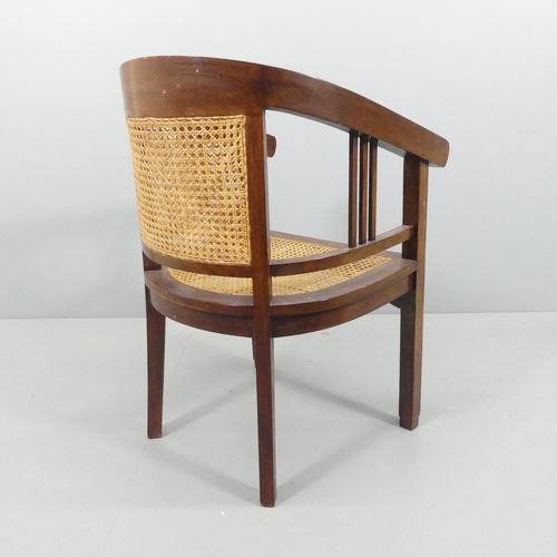 2159 - A stained teak Art Deco style bow-arm desk chair, with double cane panelled back and cane seat, with... 