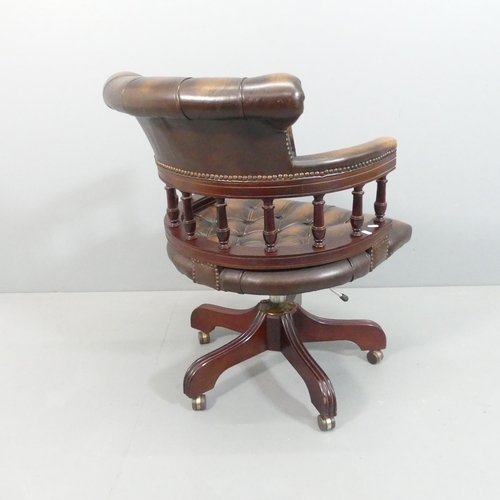 2164 - A Victorian style mahogany and button-back studded-leather upholstered bow arm swivel desk chair.