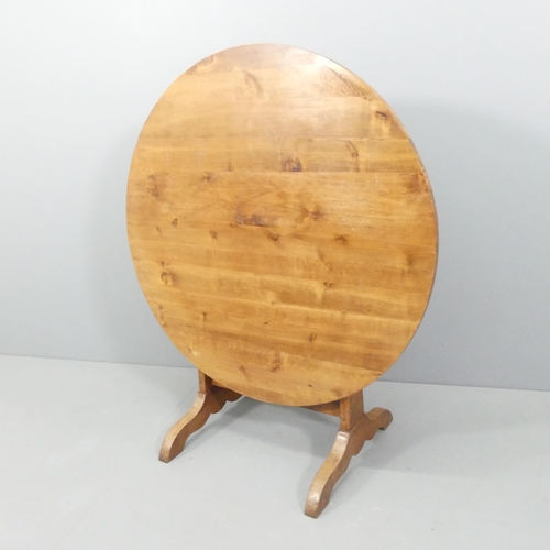 2168 - A French yew-wood tilt-top wine tasting table, on oak base with lyre decoration. 104x77cm.