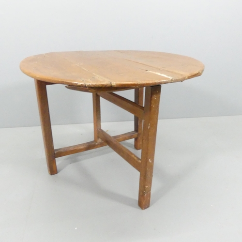 2169 - A French oak tilt-top wine table. 81x66cm.