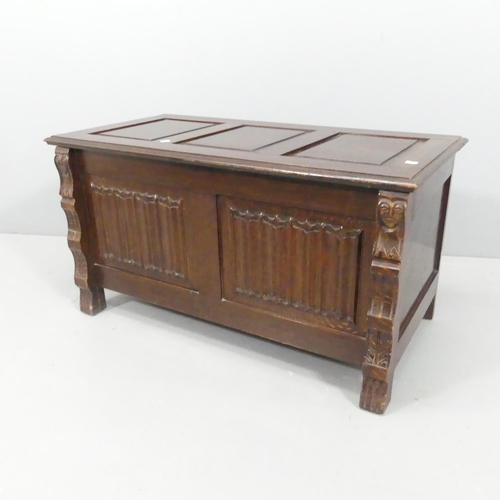 2173 - An early 20th century panelled oak blanked box, with carved linenfold decoration and raised on stile... 