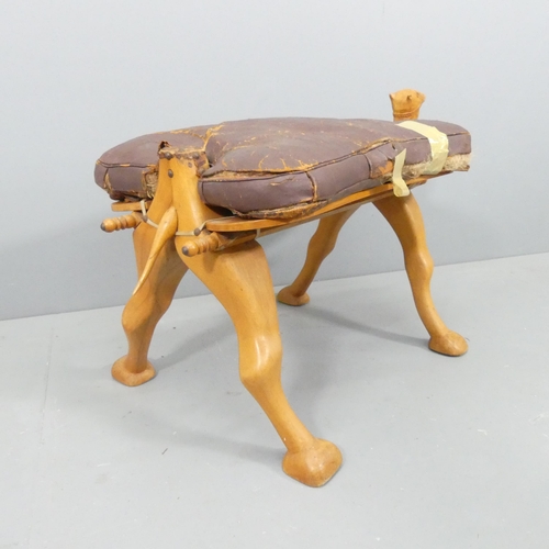 2176 - A vintage hardwood camel saddle stool. Cushion A/F. 80x50x45cm.