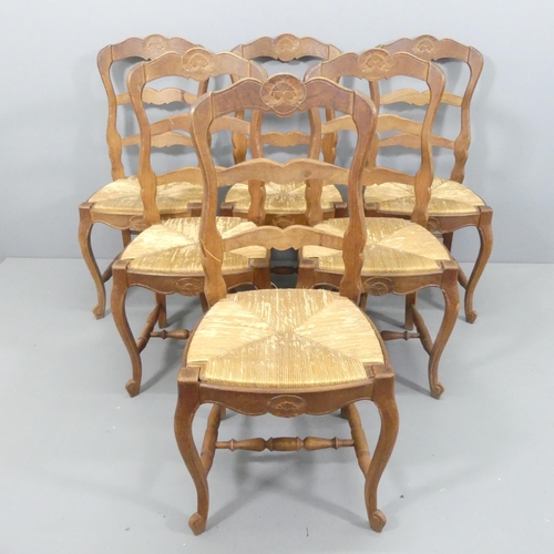 2179 - A set of six French oak ladder-back and rush-seated dining chairs.