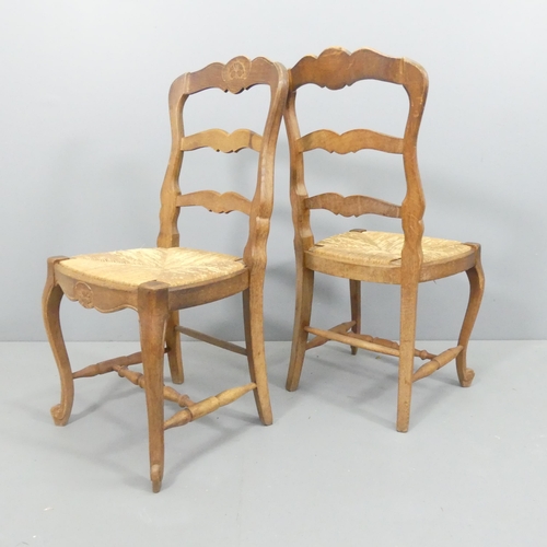 2179 - A set of six French oak ladder-back and rush-seated dining chairs.