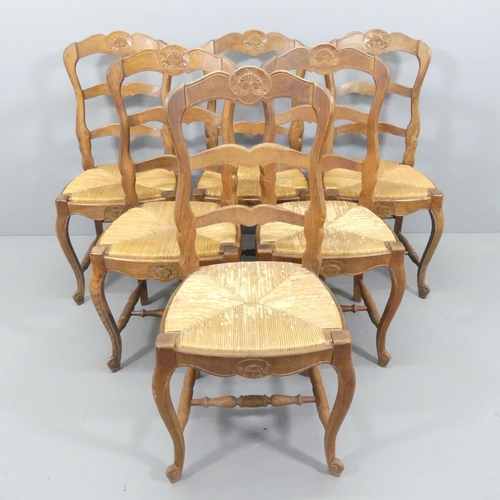 2180 - A set of six French oak ladder-back and rush-seated dining chairs.