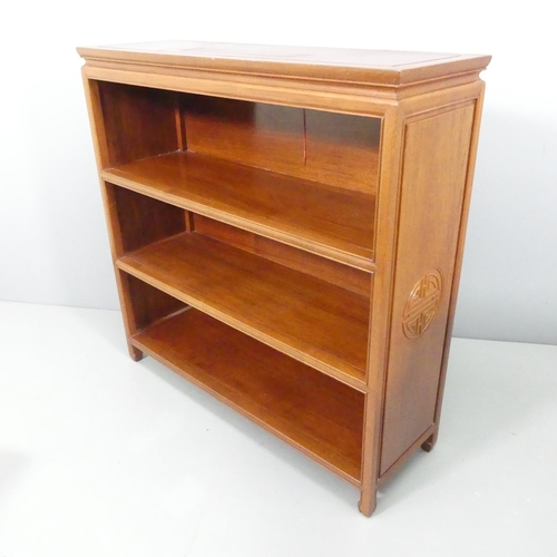 2185 - A modern Chinese hardwood open bookcase, with two fixed shelves and carved decoration. 102x102x33cm.