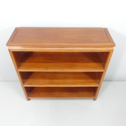 2185 - A modern Chinese hardwood open bookcase, with two fixed shelves and carved decoration. 102x102x33cm.