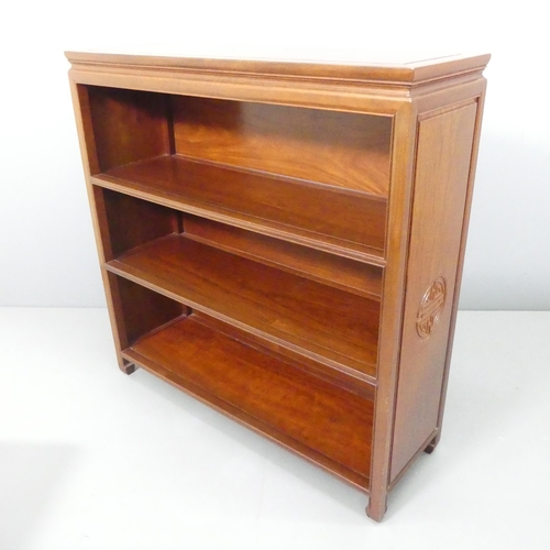 2186 - A modern Chinese hardwood open bookcase, with two fixed shelves and carved decoration. 102x102x33cm.