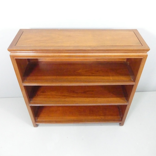 2186 - A modern Chinese hardwood open bookcase, with two fixed shelves and carved decoration. 102x102x33cm.