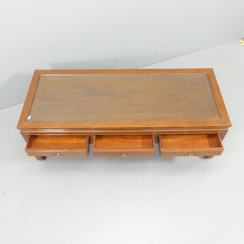 2193 - A modern Chinese hardwood coffee table, with inset glass panelled top and three frieze drawers. 127x... 