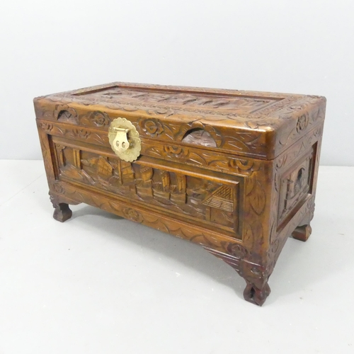 2195 - A small Chinese camphorwood blanket box, with all-over carved decoration. 69x38x33cm.