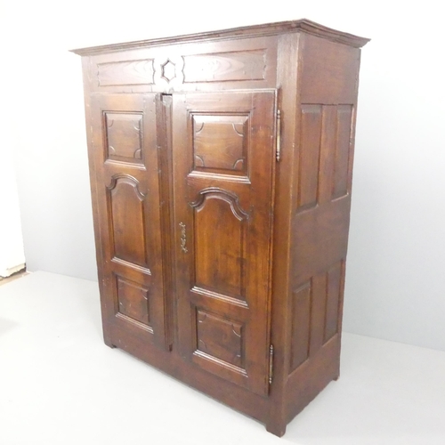 2198 - An 18th century joined oak larder cupboard, with two panelled doors, shelf fitted interior and carve... 