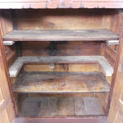 2198 - An 18th century joined oak larder cupboard, with two panelled doors, shelf fitted interior and carve... 