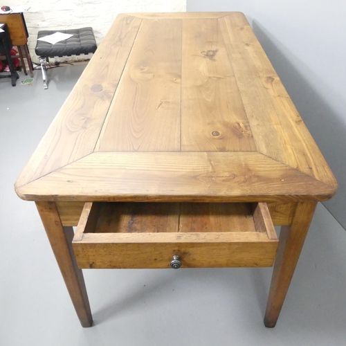 2199 - A French cherry wood and oak plank top dining table, with end frieze drawer and raised on square tap... 