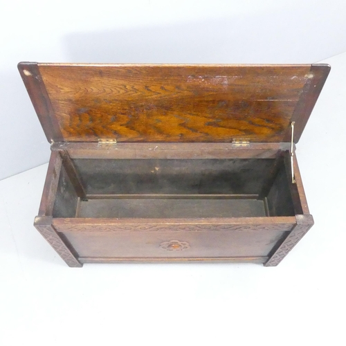 2211 - A panelled oak blanket box, with applied carved decoration. 91x48x35cm.