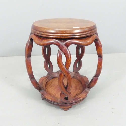 2212 - A Chinese hardwood barrel plant stand, the top having inlaid white metal decoration. 39x45cm.