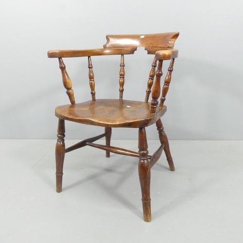 2220 - An antique elm-seated smoker's bow arm chair.