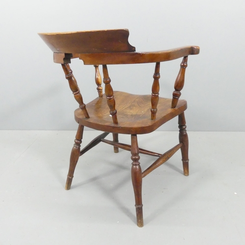 2220 - An antique elm-seated smoker's bow arm chair.