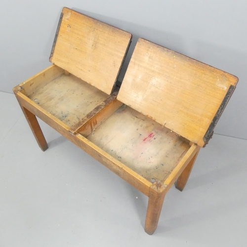 2221 - A vintage oak child's school desk, with two lifting lids. 113x64x46cm.