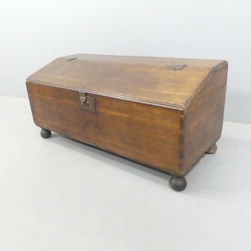 2222 - An antique oak blanket box with sloped lid. 107x49x46cm.