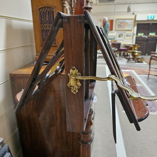 117 - A 19th century rosewood duet music stand, with brass candle brackets, adjustable column and platform... 