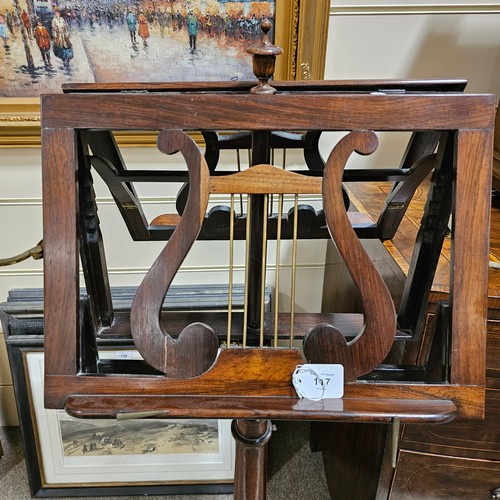 117 - A 19th century rosewood duet music stand, with brass candle brackets, adjustable column and platform... 