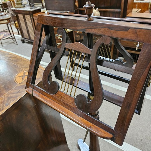 117 - A 19th century rosewood duet music stand, with brass candle brackets, adjustable column and platform... 