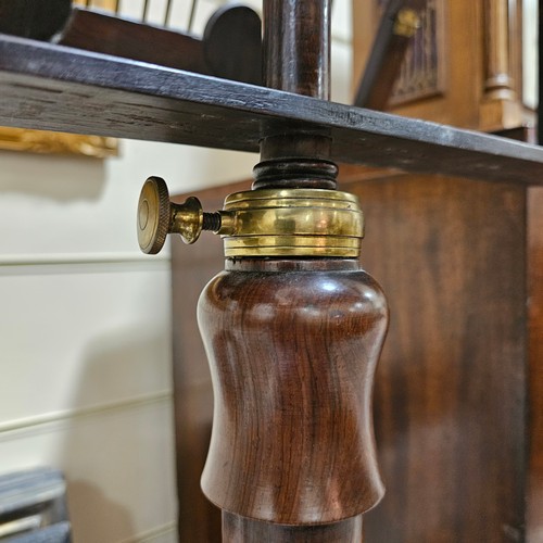 117 - A 19th century rosewood duet music stand, with brass candle brackets, adjustable column and platform... 