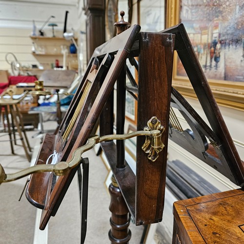 117 - A 19th century rosewood duet music stand, with brass candle brackets, adjustable column and platform... 