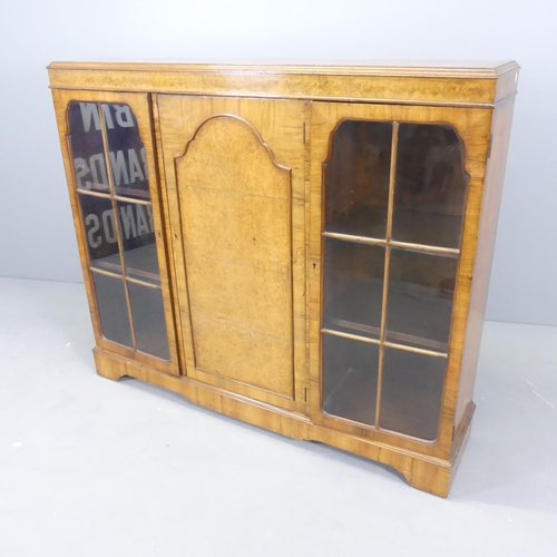 2506 - An early 20th century walnut bookcase, with two lattice glazed doors and panelled centre door. 132x1... 