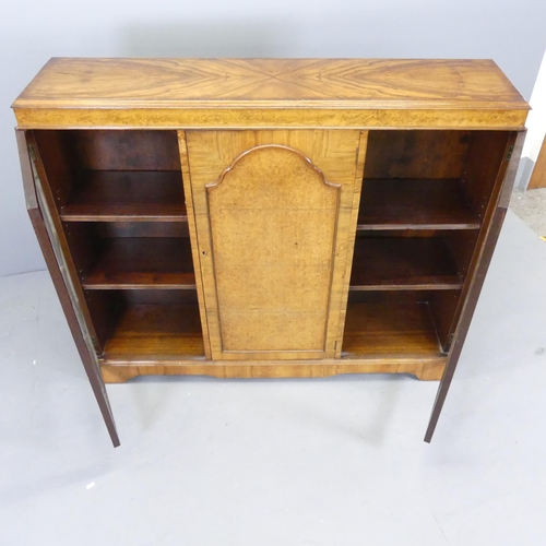 2506 - An early 20th century walnut bookcase, with two lattice glazed doors and panelled centre door. 132x1... 