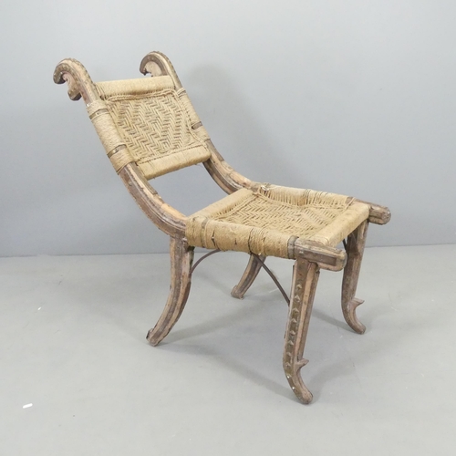 2546 - An African hardwood tribal chair, with woven seat and back panels and metal mounts. Overall 47x100x1... 