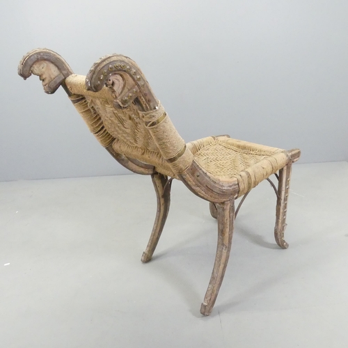 2546 - An African hardwood tribal chair, with woven seat and back panels and metal mounts. Overall 47x100x1... 