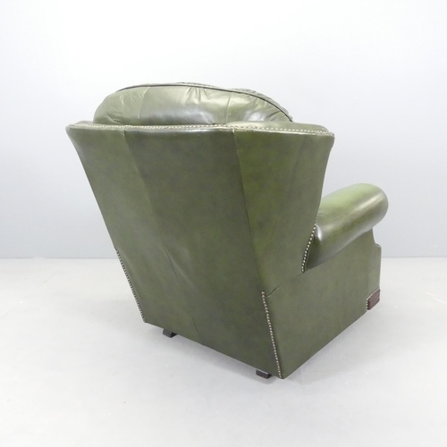 2567 - A green button back leather upholstered Chesterfield style wing back rocking chair.