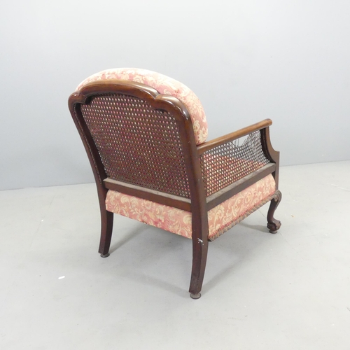 2664 - A 19th century mahogany bergere lounge chair, with label to underside for S. & H. Jewell, London. Ca... 