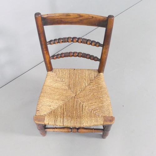 2688 - WITHDRAWN - An antique elm child's chair. Overall 38.5x66x33cm. A/F.