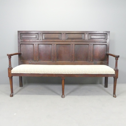 2522 - A 19th century panelled oak settle, Overall 185x115x57cm, seat 170x50x50cm.