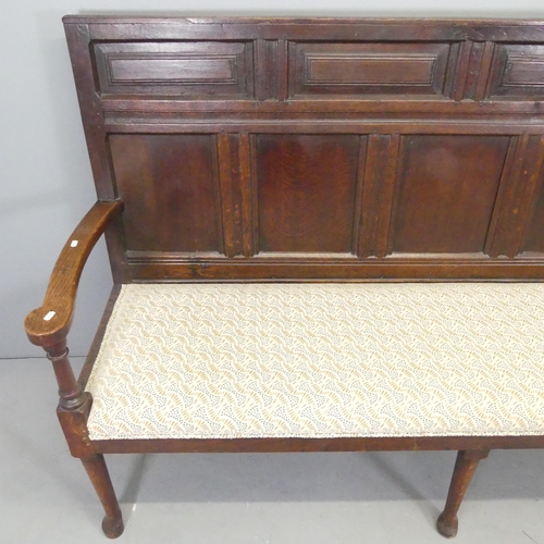 2522 - A 19th century panelled oak settle, Overall 185x115x57cm, seat 170x50x50cm.