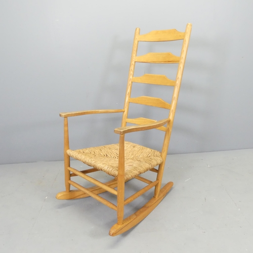 2531 - A Cotswold School style ladder-back rocking chair