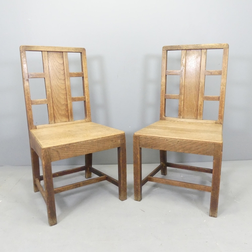 2540 - A pair of Arts and Crafts oak hall chairs with panel and lattice back in the manner of Heals.