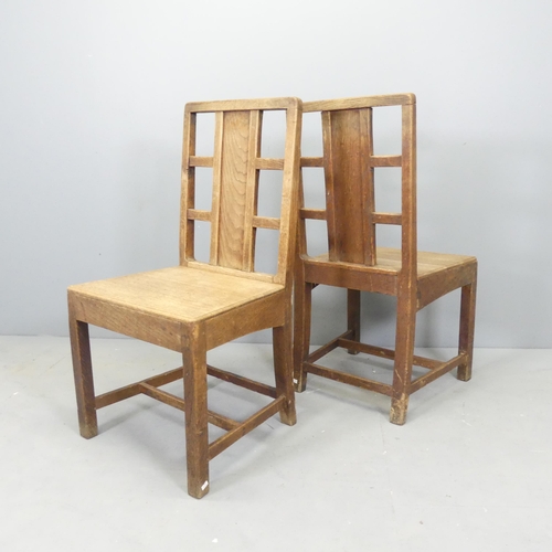 2540 - A pair of Arts and Crafts oak hall chairs with panel and lattice back in the manner of Heals.