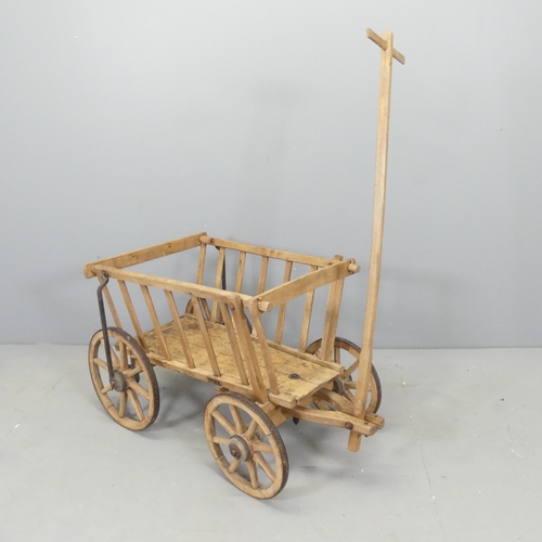 2555 - A Vintage pine dog cart. Dimensions excluding handle 91x52x50cm.