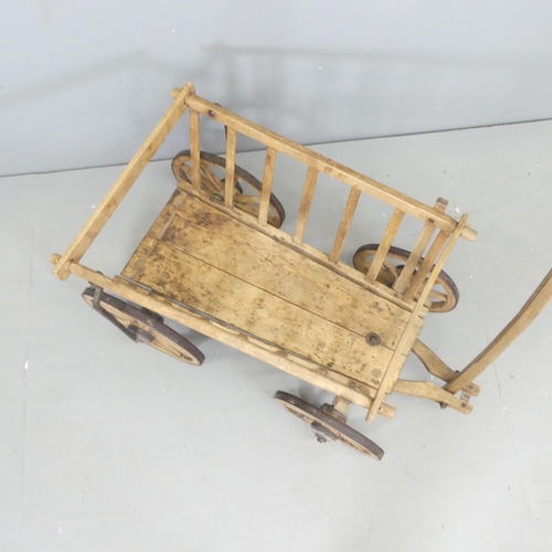 2555 - A Vintage pine dog cart. Dimensions excluding handle 91x52x50cm.