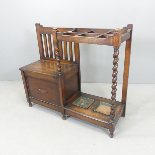 2556 - An early 20th century oak hall seat with integrated stick stand, lifting seat and original drip tray... 