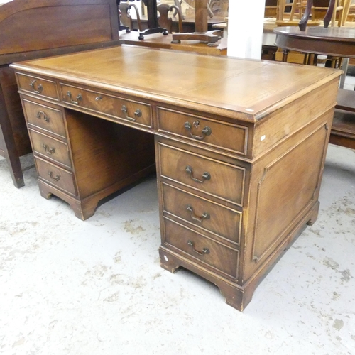 2560 - An early 20th century mahogany twin-pedestal writing desk ,with tooled and embossed brown leather sk... 