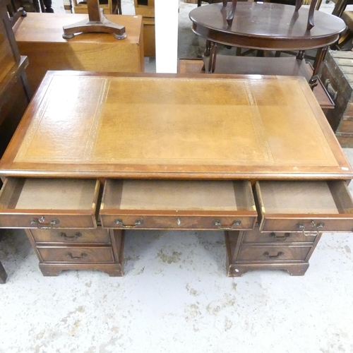 2560 - An early 20th century mahogany twin-pedestal writing desk ,with tooled and embossed brown leather sk... 