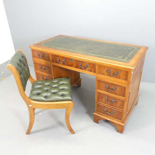 2562 - A yew-wood twin-pedestal writing desk, with label for Cross, tooled and embossed green leather skive... 