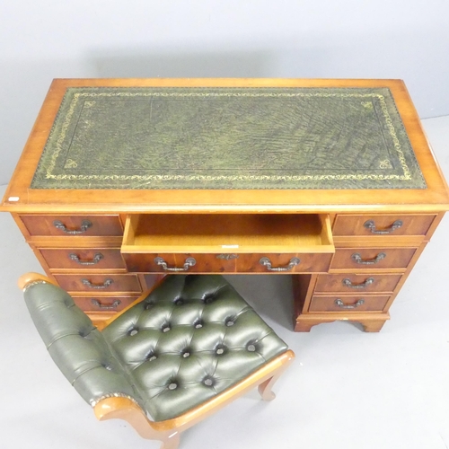 2562 - A yew-wood twin-pedestal writing desk, with label for Cross, tooled and embossed green leather skive... 