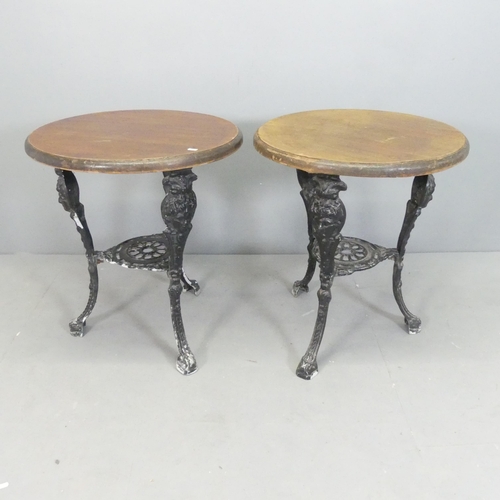 2575 - A pair of circular mahogany topped pub tables on painted cast aluminium bases. 61x70cm.