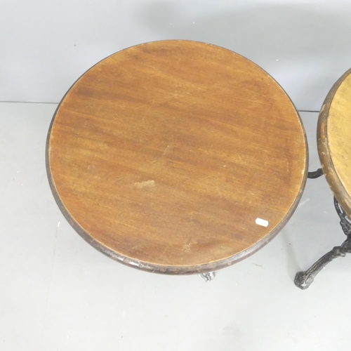 2575 - A pair of circular mahogany topped pub tables on painted cast aluminium bases. 61x70cm.